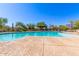 Community pool and lounge area, surrounded by mature desert trees with mountain views at 7617 E Desert Honeysuckle Dr, Gold Canyon, AZ 85118