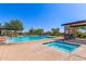 Community pool featuring a separate spa, lounge area, and shaded seating at 7617 E Desert Honeysuckle Dr, Gold Canyon, AZ 85118
