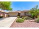 Charming single-story home boasts a well-maintained landscape, tile roof, and a welcoming two-car garage at 7617 E Desert Honeysuckle Dr, Gold Canyon, AZ 85118