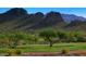 Scenic golf course view with lush green grass and a backdrop of stunning mountain views at 7617 E Desert Honeysuckle Dr, Gold Canyon, AZ 85118