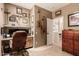 Home office with built-in desk, shelving and a view to the hall at 7617 E Desert Honeysuckle Dr, Gold Canyon, AZ 85118