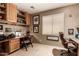 Office with built-in wood cabinets and desk and tan walls at 7617 E Desert Honeysuckle Dr, Gold Canyon, AZ 85118
