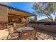 Outdoor kitchen area with seating, covered pergola, and built-in barbecue grills for community residents at 7617 E Desert Honeysuckle Dr, Gold Canyon, AZ 85118