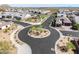 Bird's eye view of a Monteluna neighborhood street with roundabout, showcasing landscaping and nearby homes at 8055 E Jaeger St, Mesa, AZ 85207
