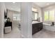 Bathroom features vanity with dark cabinets and marble countertop, tub, and tiled floors at 8055 E Jaeger St, Mesa, AZ 85207