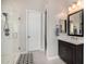 Modern bathroom featuring marble shower, dark vanity with marble top, and decorative rug at 8055 E Jaeger St, Mesa, AZ 85207