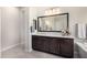 Bathroom features vanity with dark cabinets and marble countertop, tub, and tiled floors at 8055 E Jaeger St, Mesa, AZ 85207