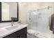 Well-lit bathroom featuring a glass shower, vanity with sink, and modern fixtures at 8055 E Jaeger St, Mesa, AZ 85207