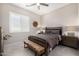 Cozy bedroom with ceiling fan, shuttered windows, and rustic wood accents at 8055 E Jaeger St, Mesa, AZ 85207