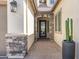 Welcoming front entrance with stone archway, patterned tile, and decorative glass door at 8055 E Jaeger St, Mesa, AZ 85207