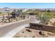 Landscaped entrance to the Monteluna community with guard shack, native plants and decorative stone signage at 8055 E Jaeger St, Mesa, AZ 85207