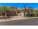 Attractive beige single-Gathering home featuring desert landscaping, a tile roof, and a brick-paved driveway at 8055 E Jaeger St, Mesa, AZ 85207