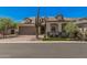 Charming single-story home with a neutral color palette, desert landscaping, and a brick-paved driveway at 8055 E Jaeger St, Mesa, AZ 85207