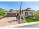 Beautiful single-Gathering home with desert landscaping, green grass, and a two-car garage at 8055 E Jaeger St, Mesa, AZ 85207