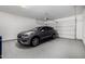 Clean, well-lit garage showcasing ample parking space for a car and epoxy flooring at 8055 E Jaeger St, Mesa, AZ 85207
