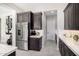 Kitchen features stainless steel refrigerator and dark wood cabinets with white counters at 8055 E Jaeger St, Mesa, AZ 85207