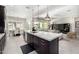 Kitchen with marble island, stainless steel appliances, adjacent to dining area and living room at 8055 E Jaeger St, Mesa, AZ 85207