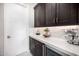 Kitchen wet bar area features dark wood cabinets, white countertops, wine cooler, and beverage center at 8055 E Jaeger St, Mesa, AZ 85207