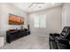Modern living room with a large TV, stylish furniture, and neutral tones at 8055 E Jaeger St, Mesa, AZ 85207