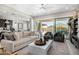 Open-concept living room with a view of the backyard pool through sliding glass doors at 8055 E Jaeger St, Mesa, AZ 85207