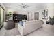 Spacious living room featuring tile floors, modern furnishings, and a ceiling fan at 8055 E Jaeger St, Mesa, AZ 85207