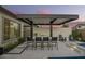 Outdoor kitchen with modern fixtures, bar seating, and a covered dining area near the pool at 8055 E Jaeger St, Mesa, AZ 85207