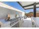 Outdoor built in stainless steel grill, side burner, and refrigerator with stucco base and stone counter top at 8055 E Jaeger St, Mesa, AZ 85207