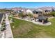 Community park in Monteluna with a picnic structure, barbecue, open green space, and mountain views at 8055 E Jaeger St, Mesa, AZ 85207