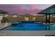 Beautiful pool with a spa, waterfall feature, and ample deck space for entertaining outdoors at 8055 E Jaeger St, Mesa, AZ 85207
