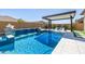 Beautiful pool with waterfall features, fire bowls, and in-water seating under a pergola, creating a serene outdoor oasis at 8055 E Jaeger St, Mesa, AZ 85207