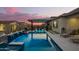 Stunning pool with a waterfall, seating area and lush landscaping, perfect for relaxation at 8055 E Jaeger St, Mesa, AZ 85207