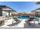 Relaxing backyard pool and spa with dual waterfall features, comfortable lounge chairs, and a covered outdoor dining area at 8055 E Jaeger St, Mesa, AZ 85207