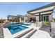 Beautiful backyard oasis with a pool, spa, outdoor kitchen, and fire pit creates a perfect retreat for relaxation and entertainment at 8055 E Jaeger St, Mesa, AZ 85207