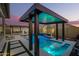 Inviting pool area featuring a Baja shelf with stylish chairs and a modern pergola with lounge area, perfect for relaxation at 8055 E Jaeger St, Mesa, AZ 85207