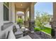 Inviting covered porch with comfortable seating and views of the green lawn at 8055 E Jaeger St, Mesa, AZ 85207