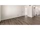 A bright, empty bedroom with wood-look floors, fresh paint, and closet at 830 E Gila Ln, Chandler, AZ 85225