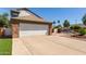 Home featuring a spacious two-car garage, long drive, and landscaped yard at 830 E Gila Ln, Chandler, AZ 85225