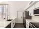 Bright, modern kitchen featuring white cabinets, stainless appliances, and wood floors at 830 E Gila Ln, Chandler, AZ 85225