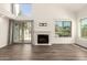 Bright living room featuring a fireplace, wood floors, and sliding door to backyard at 830 E Gila Ln, Chandler, AZ 85225