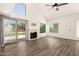 Bright living room featuring a fireplace, wood floors, and sliding door to backyard at 830 E Gila Ln, Chandler, AZ 85225