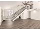 Spacious living room with wood floors, high ceilings, staircase, and bright windows at 830 E Gila Ln, Chandler, AZ 85225
