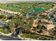 Aerial view of a well maintained golf course, community streets, and desert landscaping at 841 E Farmers Ln, Queen Creek, AZ 85140