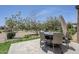 Backyard features a seating area on the travertine tile patio and desert landscaping at 841 E Farmers Ln, Queen Creek, AZ 85140