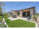 Backyard features a covered patio, artificial turf, and desert landscaping at 841 E Farmers Ln, Queen Creek, AZ 85140