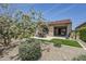 Backyard with desert landscaping, trees, and covered patio with seating area at 841 E Farmers Ln, Queen Creek, AZ 85140