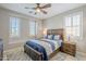 Cozy bedroom features a wooden bed frame, stylish lamps, and bright, shuttered windows at 841 E Farmers Ln, Queen Creek, AZ 85140