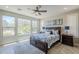 Inviting bedroom features abundant natural light, neutral walls, plantation shutters, and a ceiling fan at 841 E Farmers Ln, Queen Creek, AZ 85140