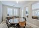 Elegant dining room with built-in cabinetry, and a glass-top table set for four at 841 E Farmers Ln, Queen Creek, AZ 85140