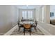 Stylish dining room with a round glass table, seating for four, and decorative rug at 841 E Farmers Ln, Queen Creek, AZ 85140