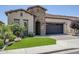 Charming exterior with brick accents, manicured lawn, a paved driveway, and lush palm tree creating curb appeal at 841 E Farmers Ln, Queen Creek, AZ 85140